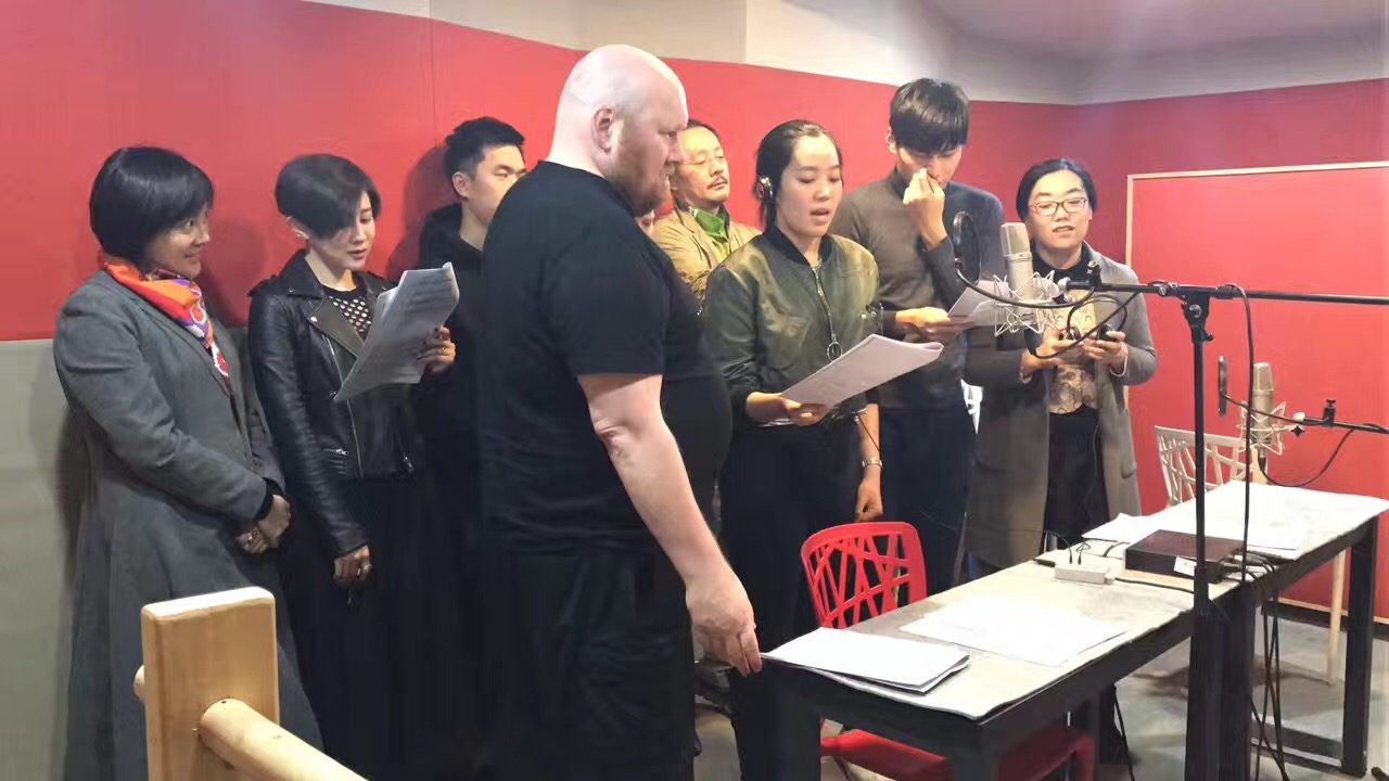 Group reading scripts at the microphone